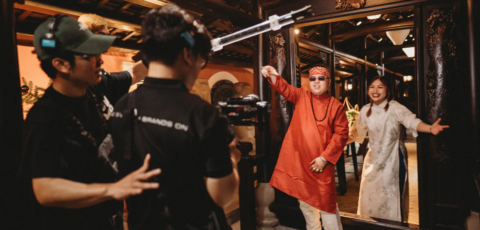 Behind the scenes — filming the rap duo in a traditional wooden house