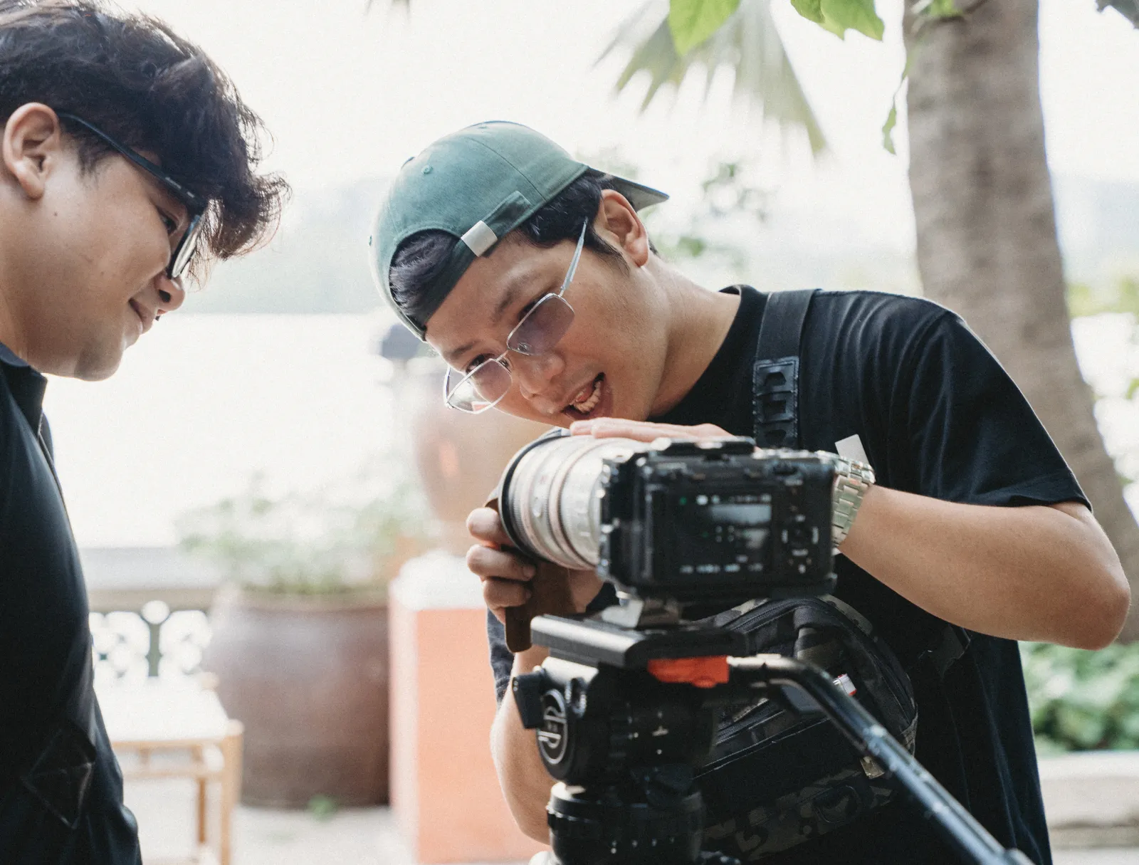Two crew members reviewing a shot on the camera outdoors